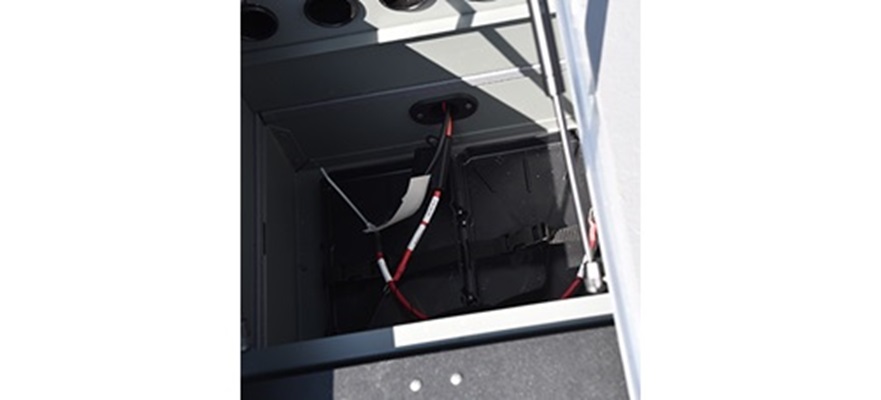Battery storage compartment including 12V or 24V bow trolling motor plug and receptacles with wiring harness